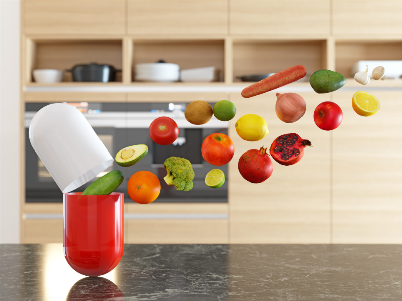 Hedelmi&auml; ja vihanneksia menossa kaaressa monivitamiinikapselin sis&auml;lle