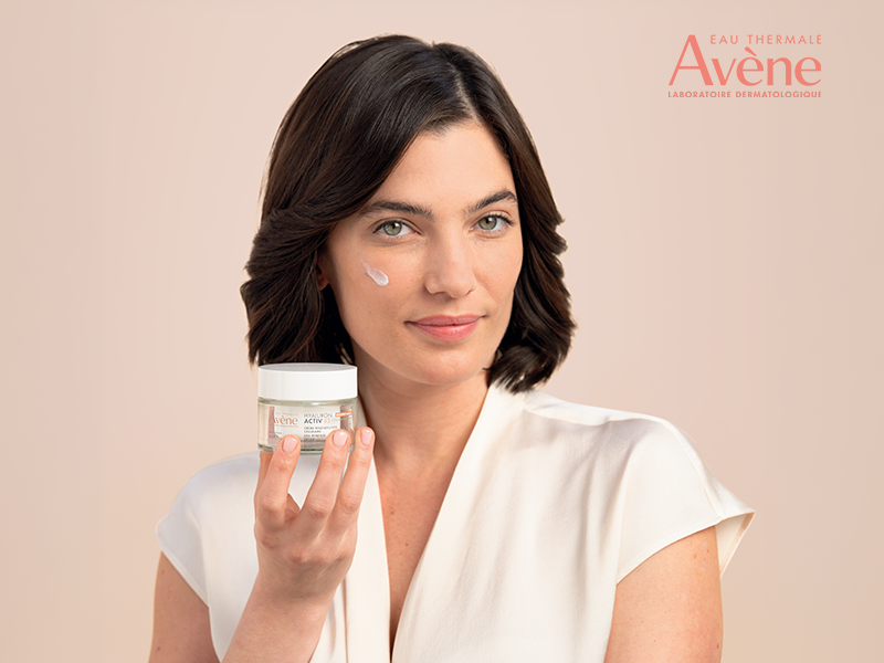 nainen pitelee k&auml;dess&auml;&auml;n Avenen hyaluron activ B3 voidetta